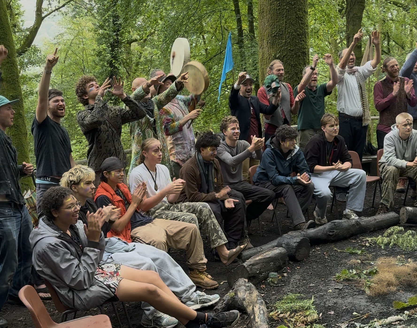 Boys and men cheering together in the woods