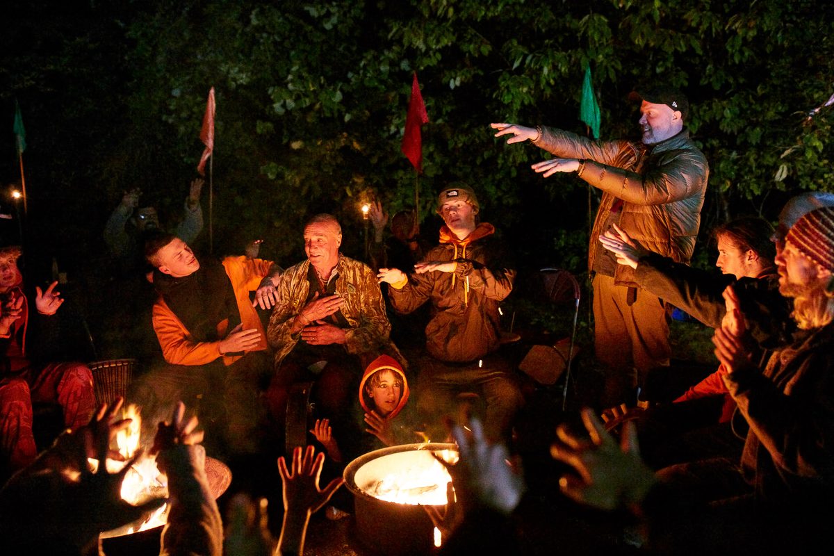 Boys and mentors around the fire at a Rites of Passage weekend